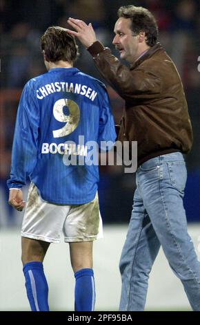 Bochum`s Spanish player Thomas Christiansen, left, and coach Peter Neururer, right, leave the pich after the quarter final German soccer cup match between VfL Bochum and 1.FC Kaiserslautern at the Ruhrstadium in the western German city of Bochum on Wednesday, Feb. 5, 2003. Bochum lost by 7-6 after penalty shooting.(AP Photo/Michael Sohn)